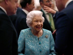 Queen Elizabeth and Prime Minister Boris Johnson greet guests at a reception for the Global Investment Summit in Windsor Castle, Windsor, Britain, Oct. 19, 2021.