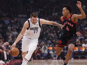 Luka Doncic #77 of the Dallas Mavericks drives against Scottie Barnes #4 of the Toronto Raptors during their NBA game at Scotiabank Arena.