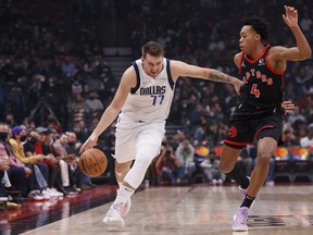 Luka Doncic #77 of the Dallas Mavericks drives against Scottie Barnes #4 of the Toronto Raptors during their NBA game at Scotiabank Arena on October 23.