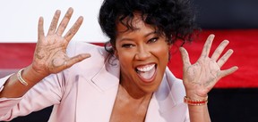 Regina King shows her hands after placing her handprints in cement during a ceremony in the forecourt of the TCL Chinese theatre in Los Angeles, Oct. 28, 2021.