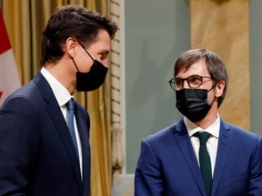 Prime Minister Justin Trudeau speaks with Minister of Environment and Climate Change Steven Guilbeault during the cabinet's swearing-in ceremony at Rideau Hall in Ottawa, Oct. 26, 2021.