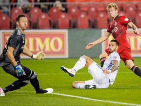 Toronto FC forward Jacob Shaffelburg (24) scores against FC Cincinnati goalkeeper Przemyslaw Tyton (22) during the second half at BMO Field on Sept. 29, 2021.