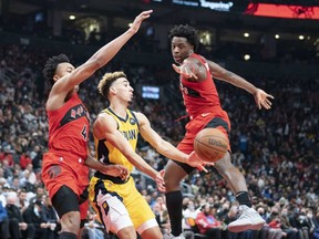 Indiana Pacers guard Chris Duarte controls the ball between Toronto Raptors forwards Scottie Barnes (left) and OG Anunoby during the second quarter at Scotiabank Arena on Oct. 27, 2021.