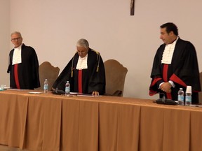 Vatican Court President Giuseppe Pignatone speaks as the Vatican Court cleared two priests charged in connection with alleged sexual abuse in a youth seminary in the Vatican between 2007 and 2012, in this still image taken from video, at the Vatican, October 6, 2021.