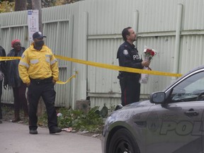 Police investigate in the area of Eglinton Ave. W. and Keefe St. early Saturday, where a man was gunned down.