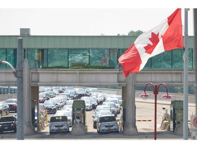 In this file photo taken on Aug. 9, 2021 travellers wait to cross into Canada at the Rainbow Bridge in Niagara Falls, Ontario, as Canada reopens for non-essential travel to fully vaccinated Americans.