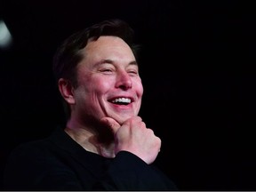 In this file photo taken on March 14, 2019, Tesla CEO Elon Musk reacts during the unveiling of the new Tesla Model Y in Hawthorne, Calif.