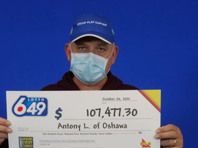 Antony Lysyk, of Oshawa, with his $107,477.30 winnings in the October 6 Lotto 6/49 draw.