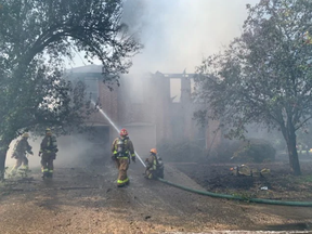 Firefighters put out a house fire in Austin on Oct. 27. Police said the man who lived there barricaded himself inside for several hours and shot at officers multiple times before police killed him.