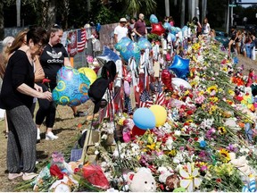 Visitors view memorials at Marjory Stoneman Douglas High School in Parkland, Florida, U.S. February 24, 2018.