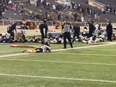 Players lie on the field as they take cover during a football game at Ladd-Peebles Stadium in Mobile, Alabama, on Friday night.