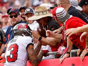 Tampa Bay Buccaneers wide receiver Mike Evans unknowingly gives away quarterback Tom Brady's (not pictured) 600 touchdown pass ball to a fan in the first half against the Chicago Bears at Raymond James Stadium.