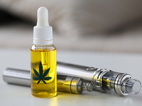 Organic extra virgin cannabinoid oil with vipe pen system against home background.