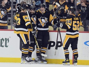 The Penguins celebrate after a second period goal by Drew OConnor (10) against the Maple Leafs at PPG Paints Arena in Pittsburgh, Saturday, Oct. 23, 2021.