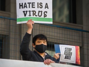 A participant holds a sign during a rally against anti-Asian hate at the Vancouver Art Gallery on March 28, 2021.