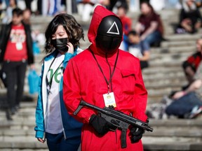 A person wearing a "Squid Game" costume attends the MCM Comic Con event outside ExCeL in London, England, Oct. 24, 2021.
