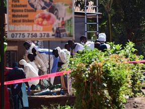 Ugandan explosives experts inspect the debris at the scene of an explosion in Komamboga, a suburb on the northern outskirts of Kampala, Uganda October 24, 2021.