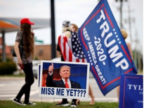 Supporters of former U.S. President Donald Trump gather on a street corner near a sign saying "Miss Me Yet???" outside the North Carolina GOP convention before Trump was expected to speak at the gathering in Greenville, North Carolina, U.S. June 5, 2021.  REUTERS/Jonathan Drake     TPX IMAGES OF THE DAY ORG XMIT: GGG-GRE124