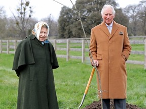Queen Elizabeth and Prince Charles stand next to the first Jubilee tree on the grounds of Windsor Castle, Britain March 23, 2021.