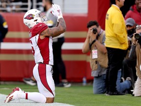 Arizona Cardinals' James Conner celebrates after scoring a touchdown during the third quarter against the San Francisco 49ers.