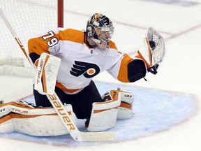Philadelphia Flyers goaltender Carter Hart makes a glove save against the Pittsburgh Penguins.