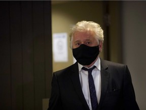 Gilbert Rozon walks past photographers at Montreal's Palais de Justice on Tuesday, Dec. 15, 2020.