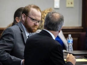 Defendant Travis McMichael speaks with his attorney Bob Rubin while they wait for the jury to return to the courtroom during the trial deliberations in the trial deliberations in the Glynn County Courthouse on Nov. 24, 2021 in Brunswick, Ga.