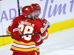 Calgary Flames' Matthew Tkachuk (right) celebrates a goal with Elias Lindholm.
