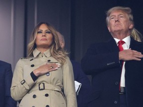 Former first lady and president of the United States Melania and Donald Trump stand for the national anthem prior to Game Four of the World Series between the Houston Astros and the Atlanta Braves Truist Park on October 30, 2021 in Atlanta, Georgia.