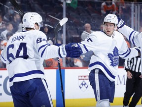Ondrej Kase of the Toronto Maple Leafs (C) celebrates with linemate Davie Kampf after scoring during the third period against the Philadelphia Flyers at Wells Fargo Center on November 10, 2021 in Philadelphia.