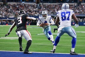 Dak Prescott of the Dallas Cowboys runs for a touchdown against the Atlanta Falcons during the third quarter on November 14, 2021 in Arlington, Texas. (Richard Rodriguez/Getty Images)