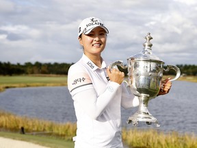 Jin Young Ko of Korea poses with the Rolex Player of the Year trophy after winning the CME Group Tour Championship at Tiburon Golf Club on November 21, 2021 in Naples, Florida.