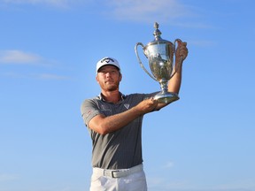 Talor Gooch of the United States celebrates with the trophy on the 18th green after winning during the final round of The RSM Classic on the Seaside Course at Sea Island Resort on November 21, 2021 in St Simons Island, Georgia.