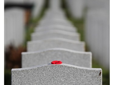 A poppy was left on a  tombstone of a soldiers in the National Military Cemetery after the Remembrance Day ceremonies at the National Military Cemetery at the Beechwood Cemetery in Ottawa, Nov. 11, 2021.