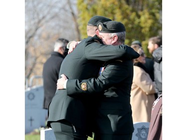 Members of the military greet each other after the Remembrance Day ceremonies at the National Military Cemetery at the Beechwood Cemetery in Ottawa, Nov. 11, 2021.