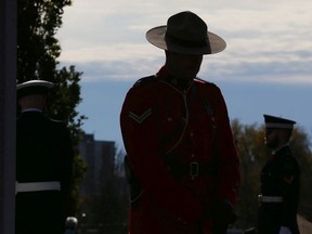 An RCMP offer stands guard during the Remembrance Day ceremonies at the National Military Cemetery at the Beechwood Cemetery in Ottawa, Nov. 11, 2021.