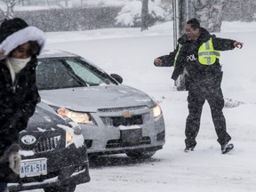It won't be long before Toronto gets hit by a major storm. A survey found that a majority of Canadians think there should be a law -- like the one in Quebec -- mandating snow tires. This file photo shows a police officer directing traffic on Eglinton Ave. during a 2016 snow storm.