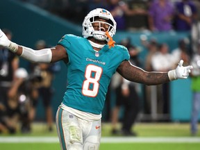 Jevon Holland #8 of the Miami Dolphins celebrates after a game-ending interception against the Baltimore Ravens.