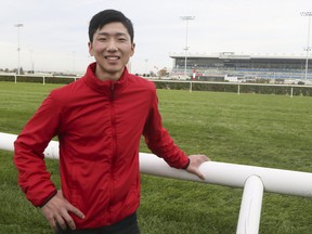 Jockey Kazushi Kimura stands in front of Woodbine Racetrack.