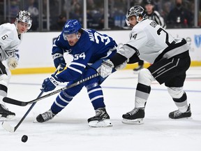 Los Angeles Kings left wing Phillip Danault (24) defends Toronto Maple Leafs centre Auston Matthews (34) in the third period of the game at Staples Center Nov. 24, 2021.