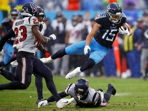 Nick Westbrook-Ikhine of the Tennessee Titans falls over a Houston Texans defender.