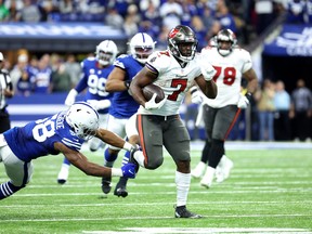 Leonard Fournette of the Tampa Bay Buccaneers carries the ball down the field.