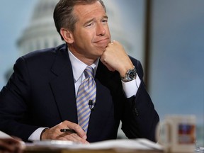 Moderator Brian Williams watches a video which pays tribute to late moderator Tim Russert during a taping of "Meet the Press" at the NBC studios June 22, 2008 in Washington, D.C.