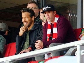 Wrexham owners Ryan Reynolds and Rob McElhenney in the stands at Racecourse Ground in Wrexham as the team takes on Torquay United on October 30, 2021.