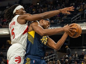 Pacers’ Myles Turner (right) rebounds the ball against Raptors’ Precious Achiuwa on Monday night. Achiuwa struggled in the game and was taken out of the starting five.