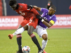 Pacific FC midfleider Jamar Dixon (right) tries to take the ball off Toronto FC midfielder Noble Okello during the Canadian Championship semifinal at BMO Field.