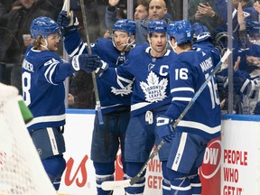 Toronto Maple Leafs centre John Tavares (91) celebrates with Mitchell Marner (16) and William Nylander (88) during a game against the Tampa Bay Lightning at Scotiabank Arena.