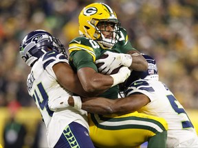 Packers running back AJ Dillon is tackled by the Seahawks. With Aaron Jones out, Dillon will get the start against the Vikings on Sunday.
