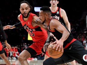 Portland Trail Blazers guard CJ McCollum (3) drives to basket on Toronto Raptors guard Gary Trent Jr. (33) during the first quarter of the game at Moda Center in Portland on Monday night.