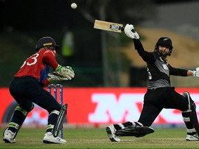 New Zealand’s Devon Conway (right) plays a shot as England’s wicketkeeper Jos Buttler watches at the Twenty20 World Cup semifinal match in Abu Dhabi yesterday.